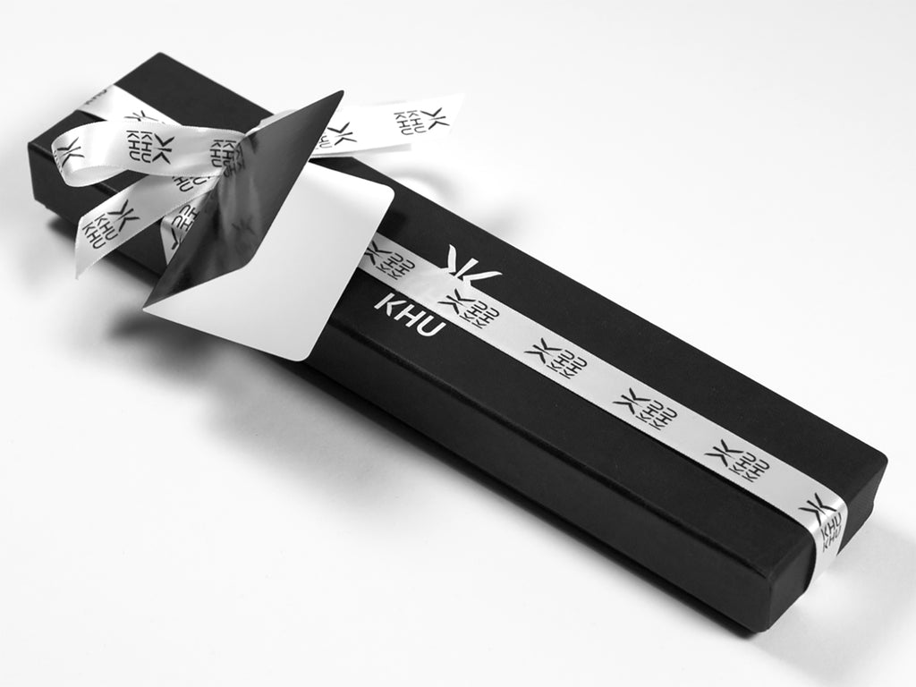 Khu Khu luxury hand-fan gift wrap. The fan is wrapped in a cotton bag then tissue wrapped and placed in a luxury black box with white logo, with additional ribbon and black glossy tag.  