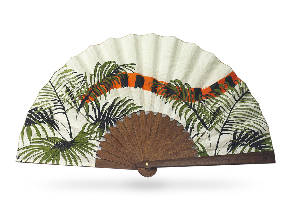 Khu Khu Indian Tiger luxury hand-fan. Hand screen printed orange and black Indian Tiger tail swishes through tropical green fern leaves with cream background mounted with premium cherry wood in exclusive Khu Khu shape with polished brass rivets. .